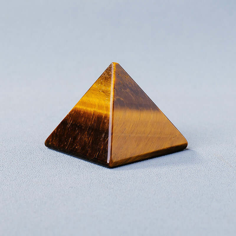 Geometric crystal energy generator pyramid in polished stone for meditation and mindfulness practices.