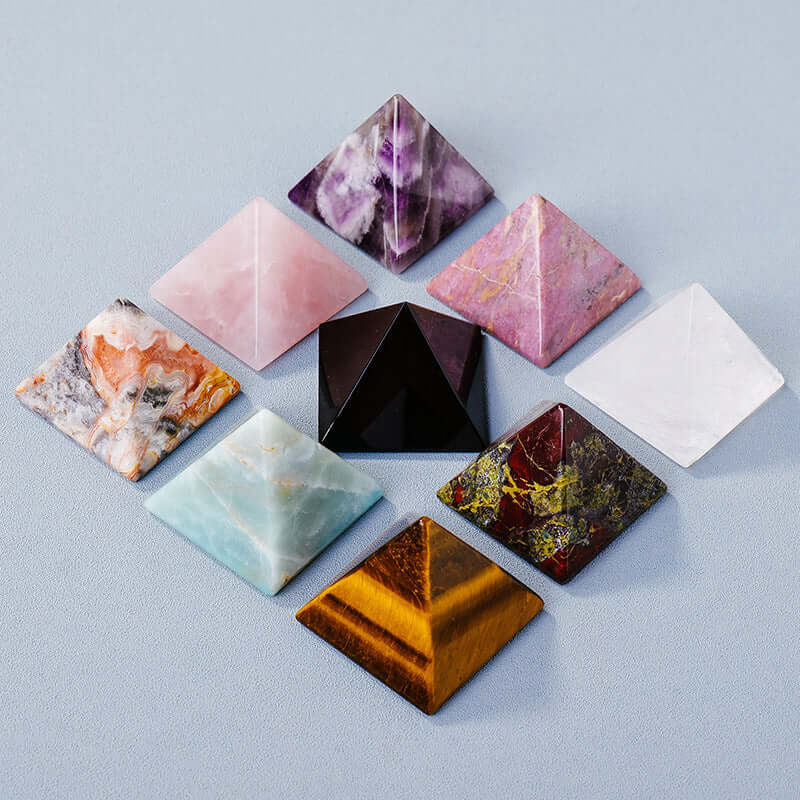 Crystal stone pyramid ornaments in various colors for meditation and mindfulness. High-quality polished energy generators.