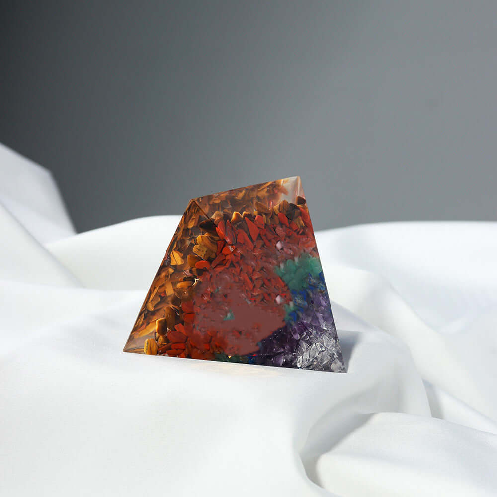 Geometric crystal stone pyramid with natural colors, perfect for orgone energy healing and enhancing spaces with modern design.